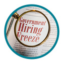 hiring-freeze announcement on newspaper