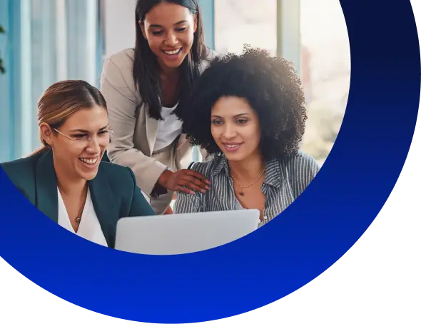 group of colleagues operating a laptop and smiling